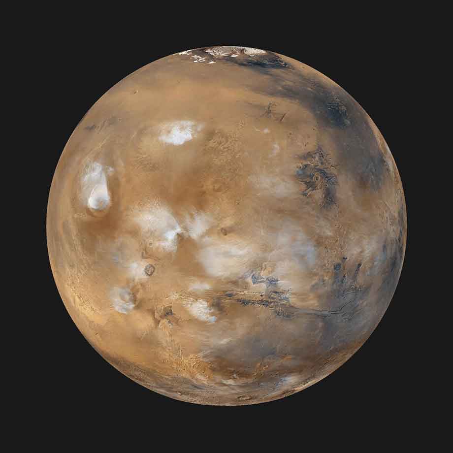Twelve orbits a day provide NASA Mars Global Surveyor MOC wide angle cameras a global napshot of weather patterns across the planet. Here, bluish-white water ice clouds hang above the Tharsis volcanoes. Unveiling the Red Planet: Choosing the Ideal Telescope to Observe Mars